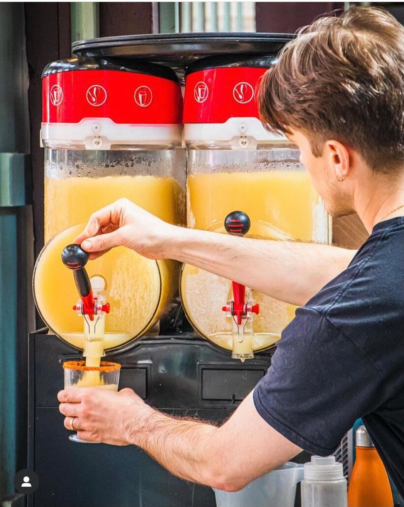 Pouring a frozen margarita from the slush machine
