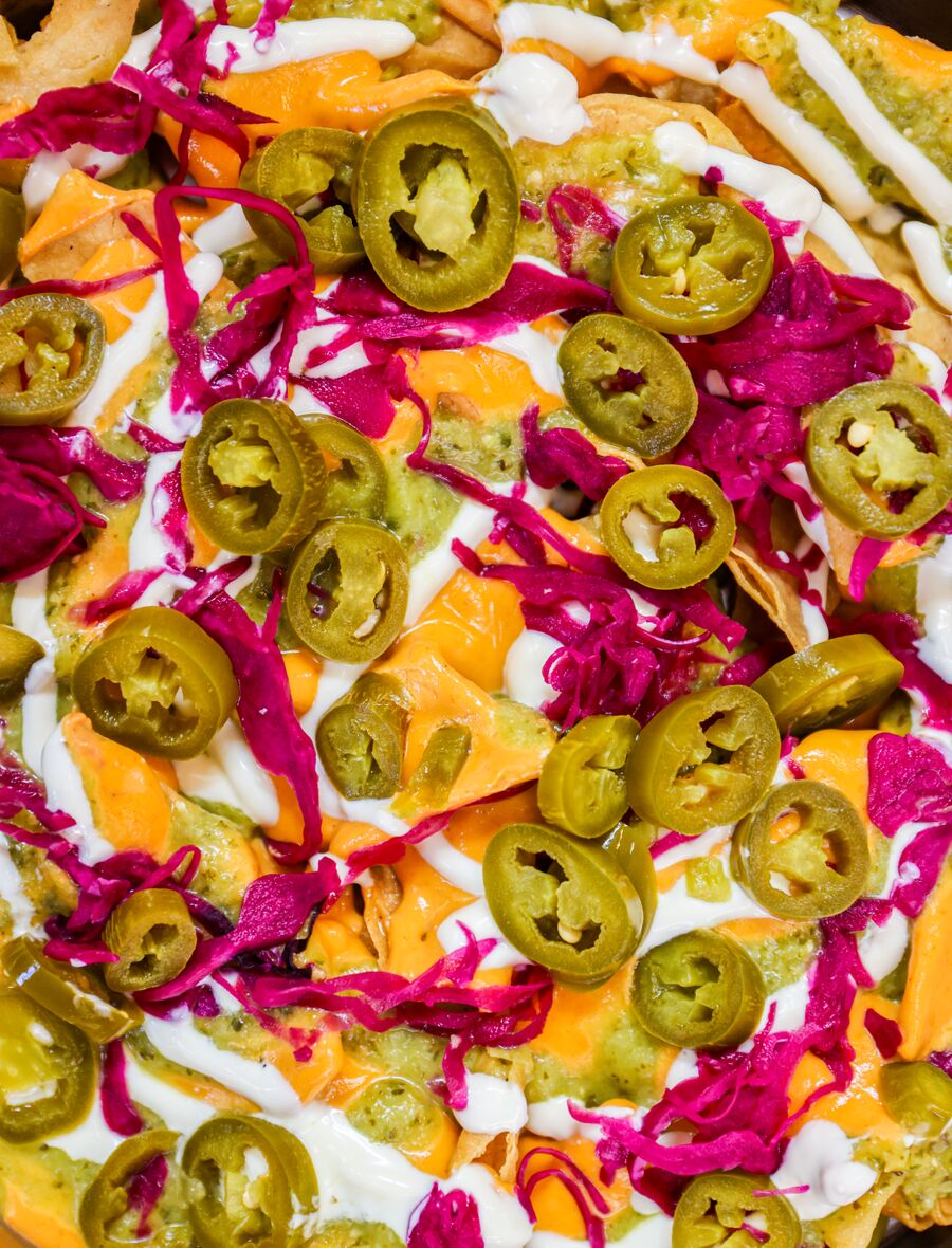 Nachos with pickled jalapeños and red cabbage