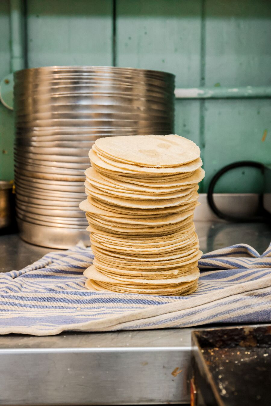 A stack of fresh handmade corn tortillas